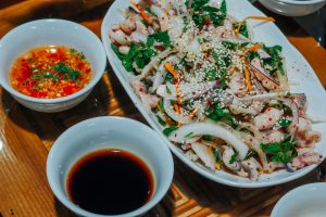 thinly sliced grilled hemibagrus fish  mixed with fresh herbs, vegetables, and a tangy dressing